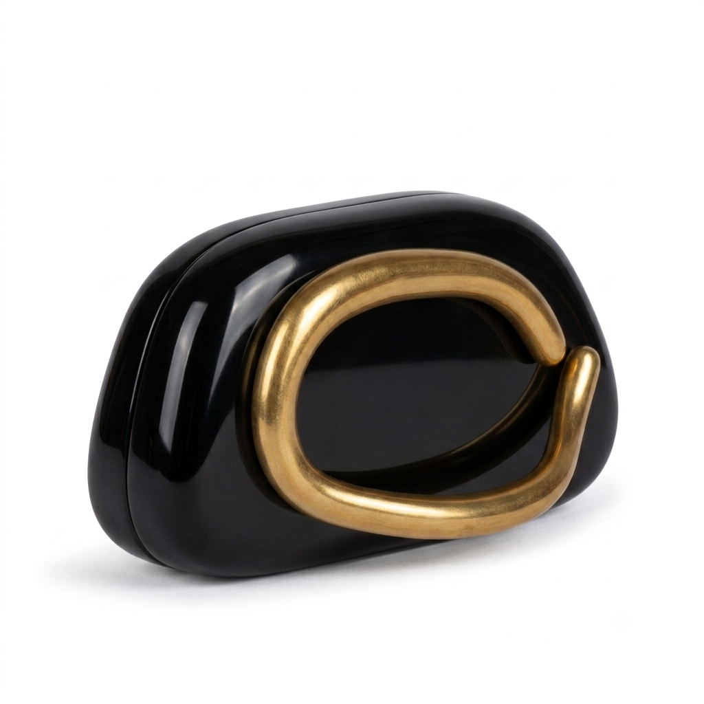 Black pillow clutch with sculptural gold ring handle