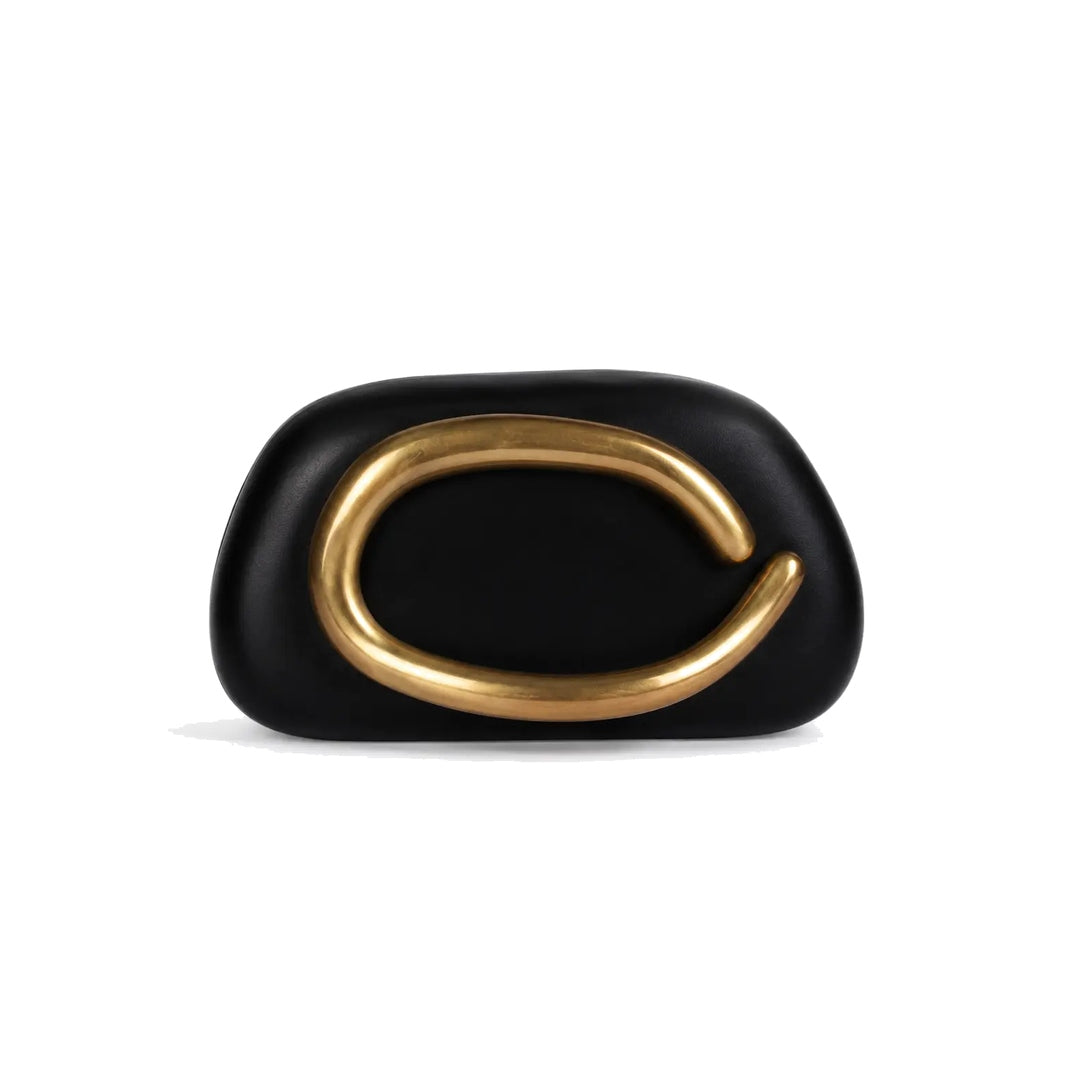 Black pillow clutch with sculptural gold ring handle