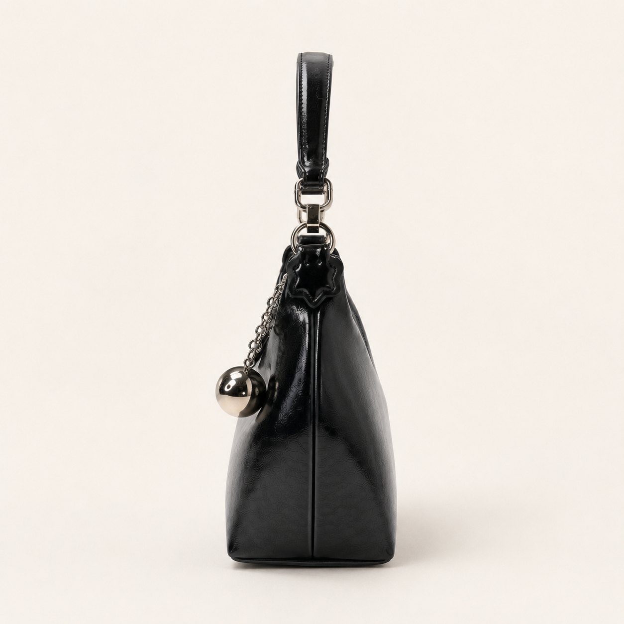 Black vegan leather curved hobo bag with silver orb charm and chain strap