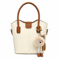 Ivory bucket tote bag with tan trim and pom-pom charm